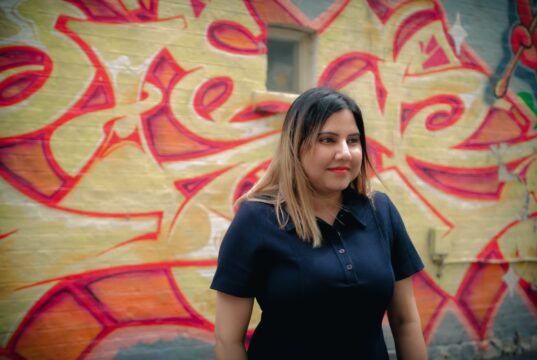 Bharati Babbar on how ApplyKart, an all-professional networking platform, is changing the job seeking hunt for the new generation A person standing in front of a wall with graffiti Description automatically generated